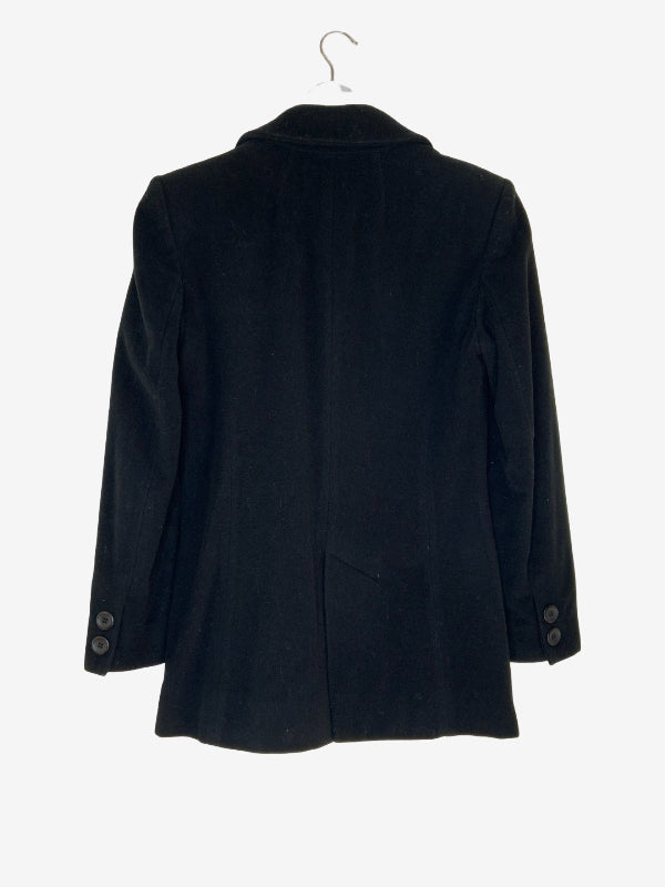 A black wool-blend blazer jacket hanging on a metal hanger against a plain white background, showing the back view with button details on the cuffs.