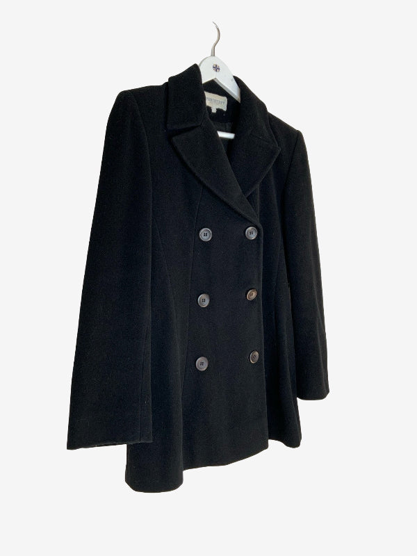 A black double-breasted coat with wide lapels and dark buttons, hanging on a white hanger against a light gray background.