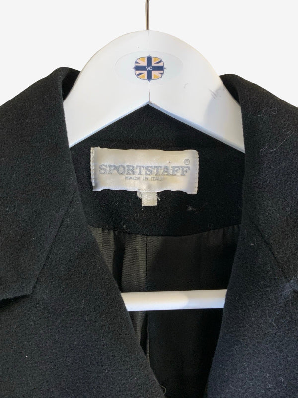 A close-up of a black Sportstaff coat hanging on a white hanger with a Union Jack logo, showing the interior neck label.