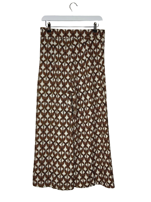 A brown and beige geometric patterned midi skirt hanging from a white hanger against a white background.