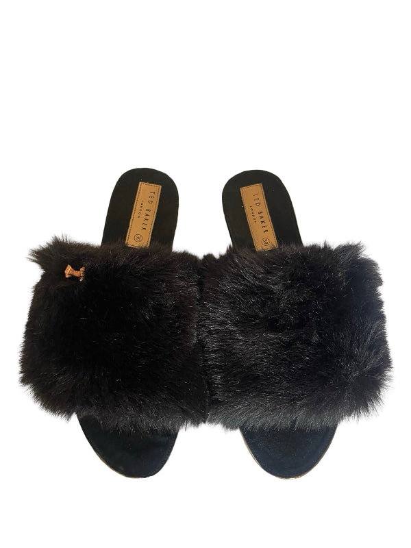 A pair of black fur slide sandals with black suede soles and tan insoles, shown from a top-down view on a white background.
