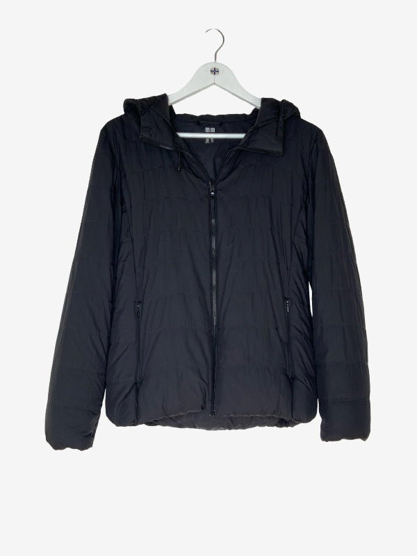 A black hooded puffer jacket hanging on a white hanger against a light gray background.