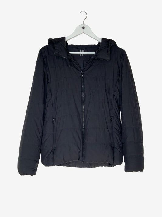A black hooded puffer jacket hanging on a white hanger against a light gray background.