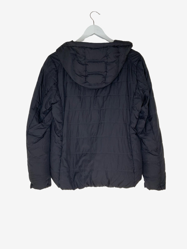 A black hooded puffer jacket shown from the back, hanging on a white wooden hanger against a light gray background.