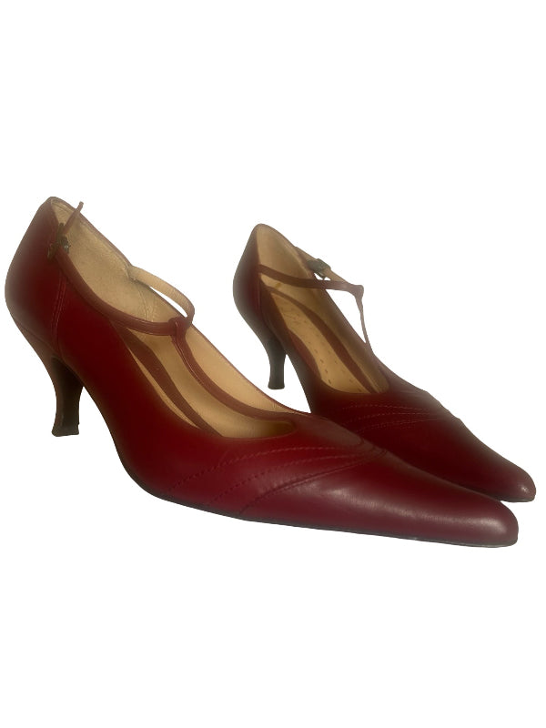 A pair of women's pointed-toe mid-heel pumps in deep burgundy red leather with thin ankle straps, shown against a plain white background.