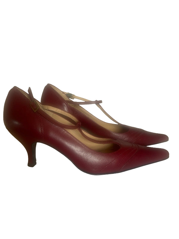 A pair of women's pointed-toe heeled pumps in a deep burgundy red leather, featuring a low kitten heel and a thin ankle strap with a small gold buckle, shown against a plain white background.