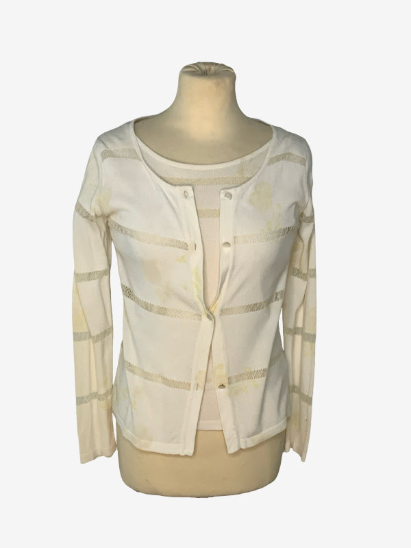 A cream-colored long-sleeve cardigan with horizontal cut out stripes, displayed on a beige mannequin torso against a light gray background.