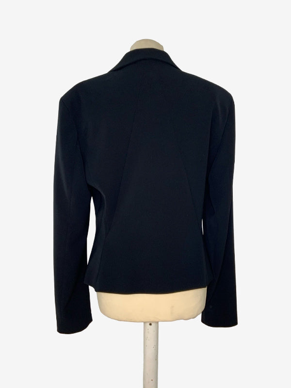 A black long-sleeve blazer shown from the back on a cream-colored dress form mannequin, set against a plain white background.