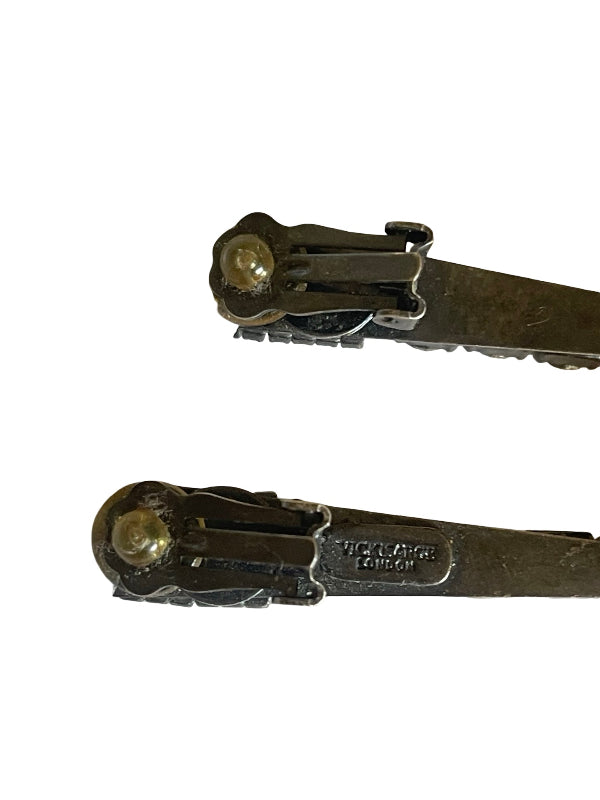 A pair of vintage metal snap hooks or clips shown against a plain white background, with one piece showing a stamped 'Vicki Sarge LONDON' brand mark.