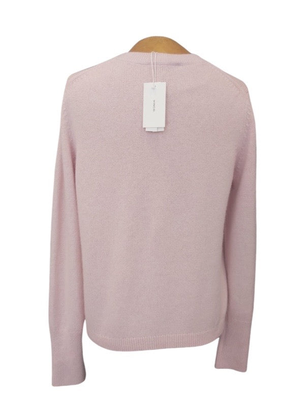 The back pale pink soft round neck jumper with tags at neck