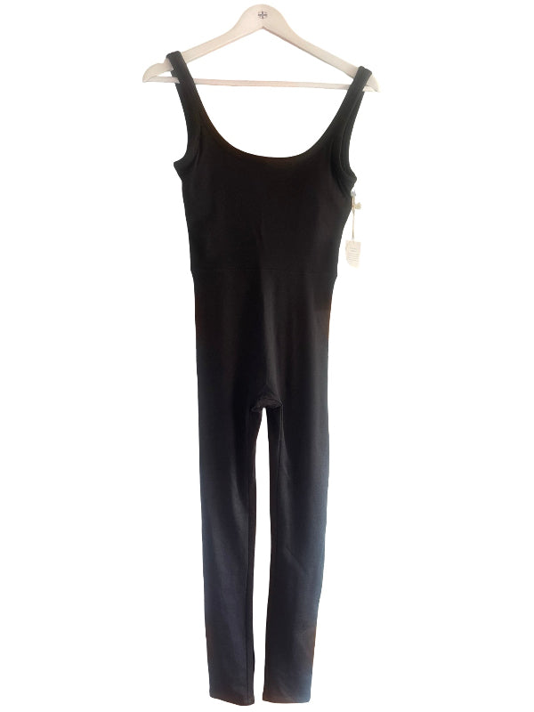 A black sleeveless jumpsuit hanging on a white wooden hanger against a plain white background.