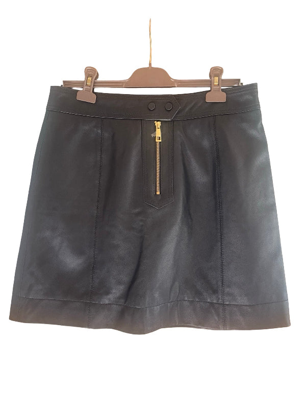 A black leather mini skirt with a gold zipper detail  at the front, hanging on a wooden hanger against a white background.