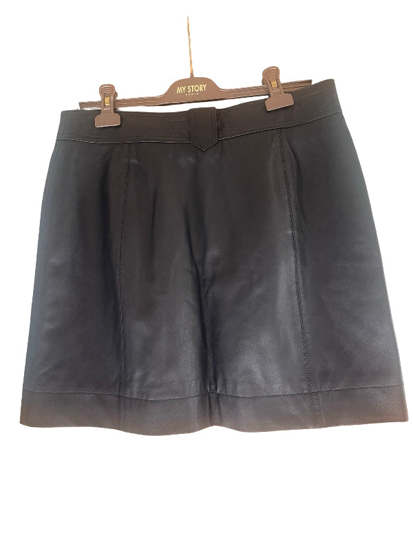 A black leather mini skirt back view  from a brown wooden hanger with the brand name 'MY STORY Paris' visible on it, set against a plain white background