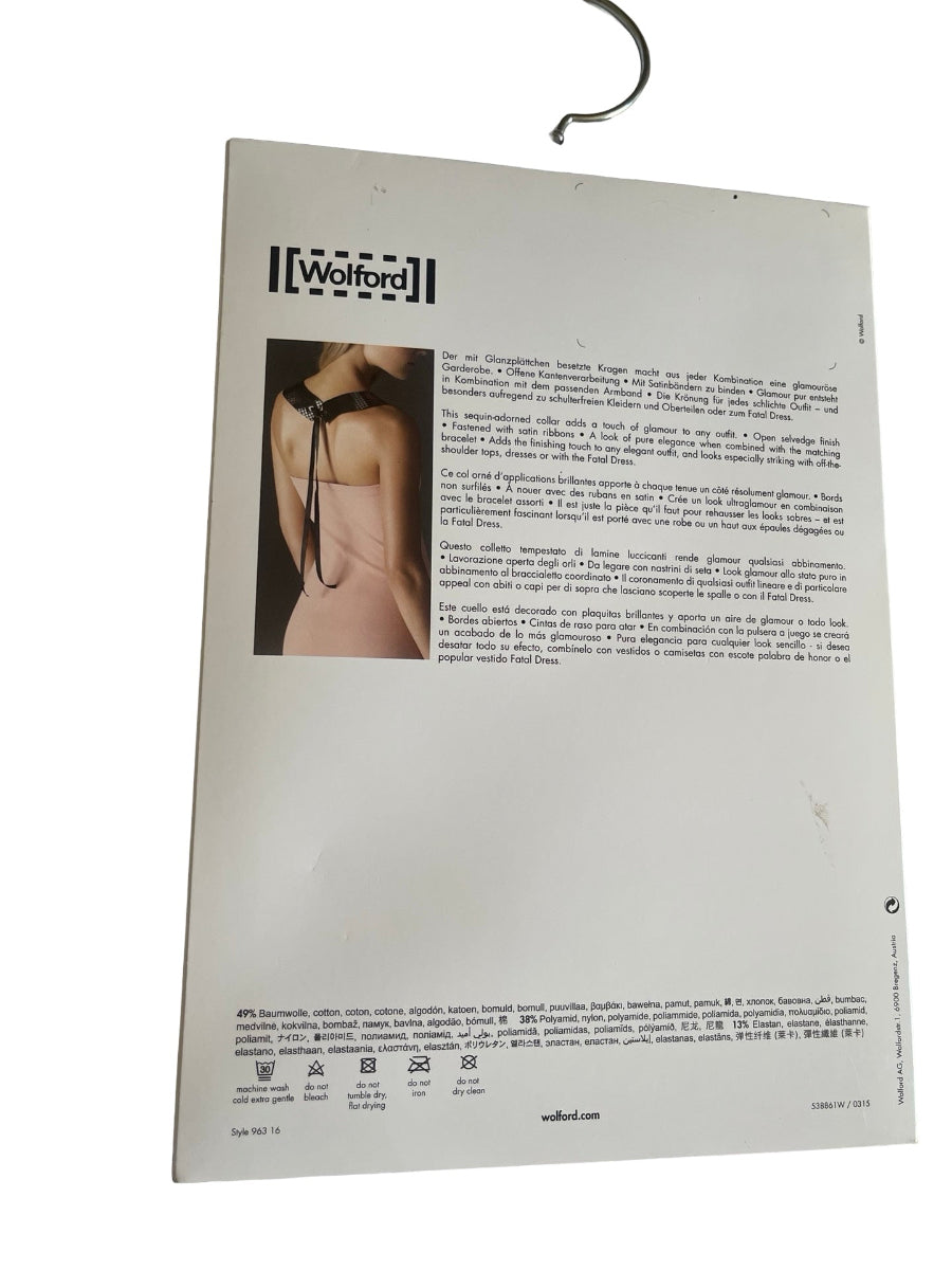 The back of a Wolford product card or packaging insert, featuring product information in German, a small inset photo of a model wearing a black choker, and a metal hanger at the top, photographed against a white background.