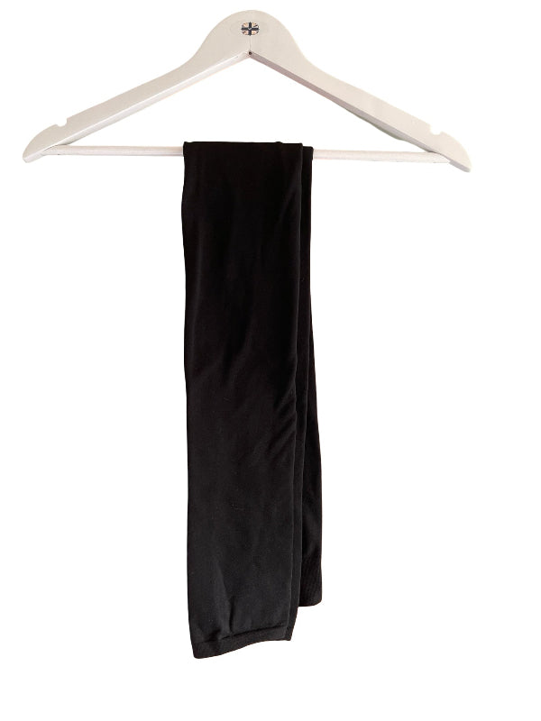 Black leggings draped over a white wooden hanger against a plain white background.