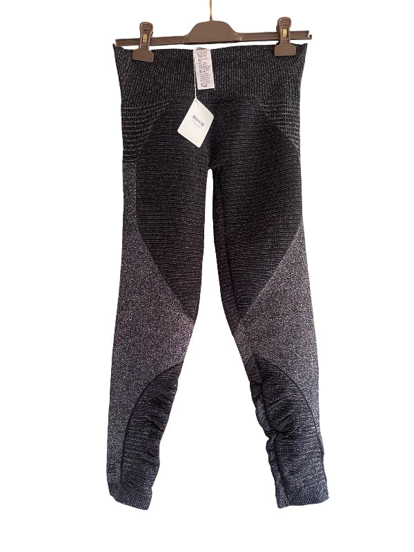 A pair of women's knit leggings in a heathered black and gray color-blocked design, hanging from a brown wooden hanger with tags attached against a plain white background.