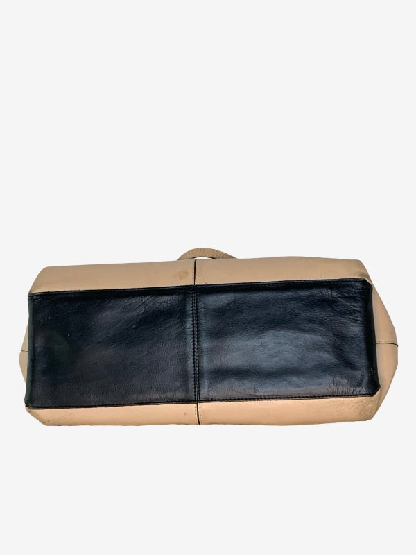 A rectangular leather  bag  base with a two-tone design, featuring a black leather front panel and beige leather sides and top handle, shown against a plain light gray background.