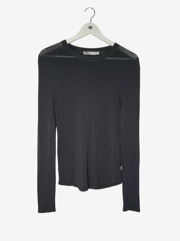 A charcoal  long-sleeve crewneck top with sheer mesh shoulder panels, hanging on a white hanger against a light gray background.