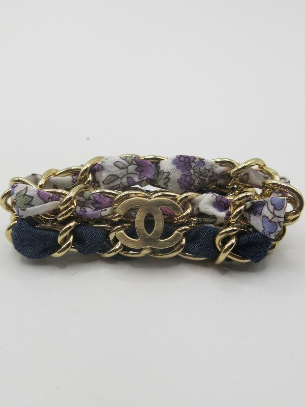 denim and floral print fabric bracelet threaded through gold chain with CC detail