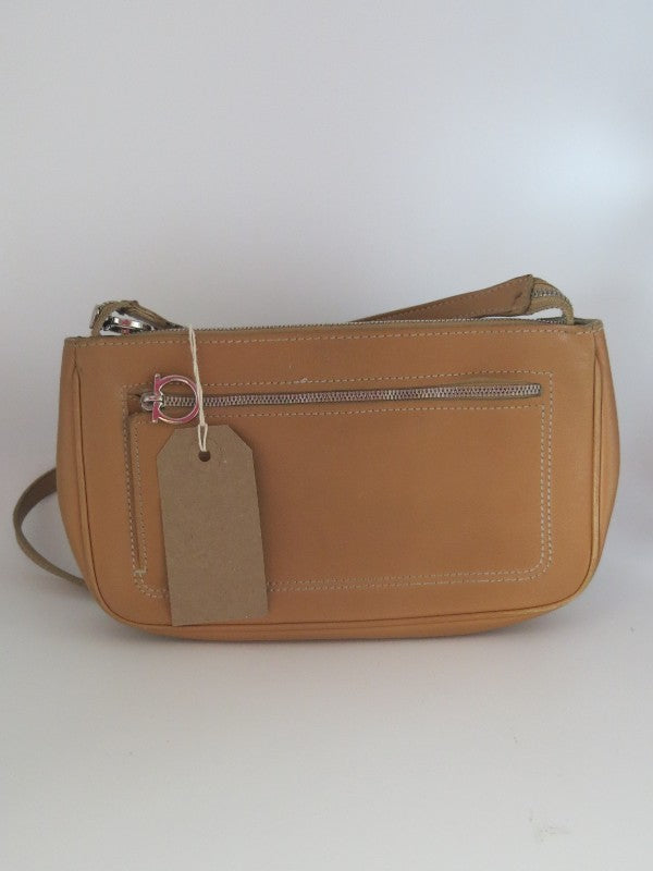 Small tan leather pouchette with short shoulder strap