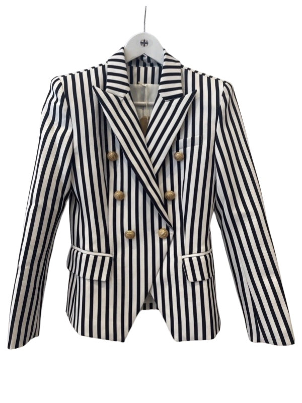A black and white striped blazer jacket with a double-breasted front and gold hardware, displayed on a mannequin.