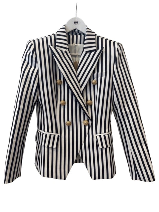 A black and white striped blazer jacket with a double-breasted front and gold hardware, displayed on a mannequin.
